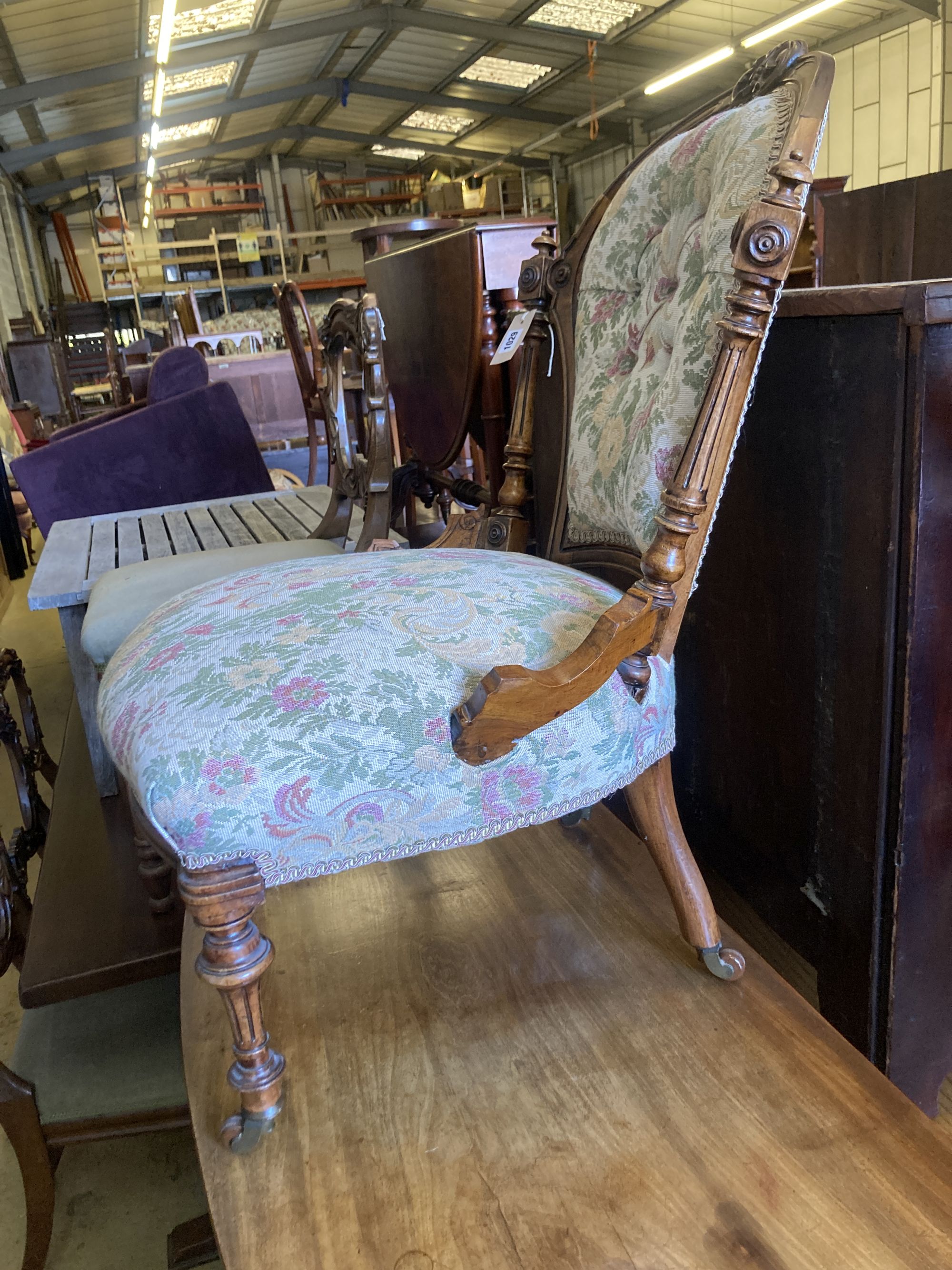 A Victorian carved walnut spoon back nursing chair, width 54cm, depth 56cm, height 80cm